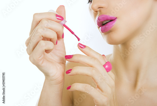 Photo: manicure process - beautiful girl makes pink manicure manicure process - beautiful girl makes pink manicure