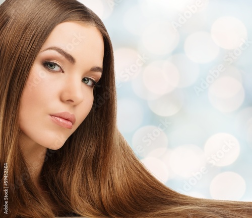 Photo: Beautiful young girl with long over blurred background Beautiful young girl with long over blurred background