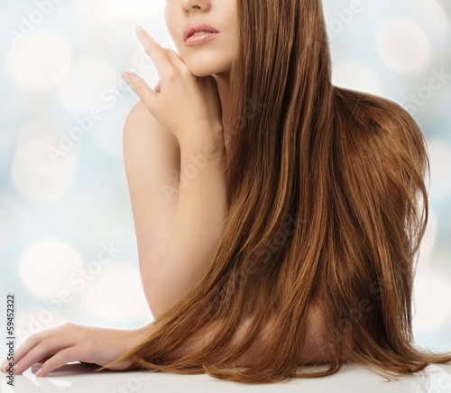 Photo: Beautiful young girl with long over blurred background Beautiful young girl with long over blurred background