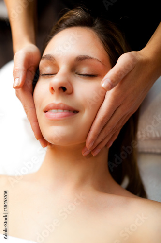Photo: Woman having a massage in a spa Woman having a massage in a spa