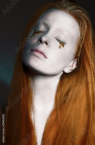 Photo: Dreamy Woman's Face with Creative Bronzed Make-up. Art Nouveau Dreamy Woman's Face with Creative Bronzed Make-up. Art Nouveau