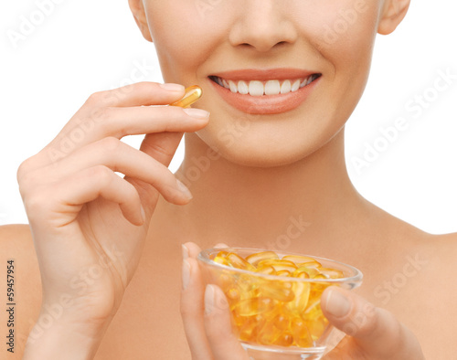 Photo: beautiful woman with omega 3 vitamins beautiful woman with omega 3 vitamins