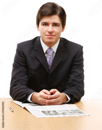 Photo: young business man on a desk, isolated on white young business man on a desk, isolated on white