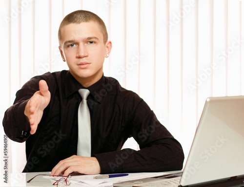 Photo: Portrait of a business man giving his hand Portrait of a business man giving his hand