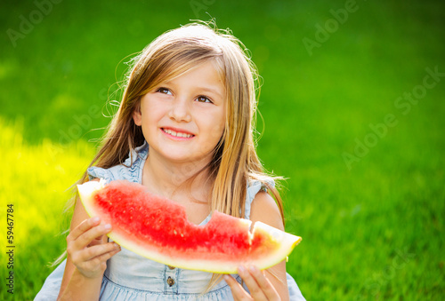 Photo: Cute little girl eating watermelon Cute little girl eating watermelon