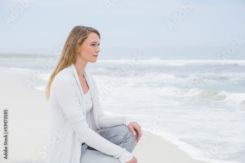 Photo: Casual young woman relaxing at beach Casual young woman relaxing at beach