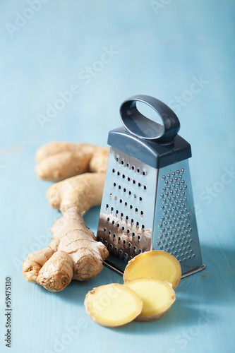 Photo: fresh ginger root and grater over blue fresh ginger root and grater over blue