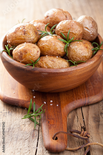 Photo: baked potatoes in wooden bowl baked potatoes in wooden bowl