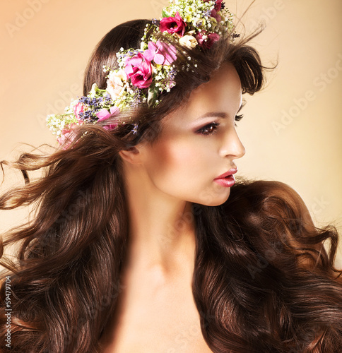 Photo: Young Auburn Woman with Long Flowing Hairs and Wildflowers Young Auburn Woman with Long Flowing Hairs and Wildflowers