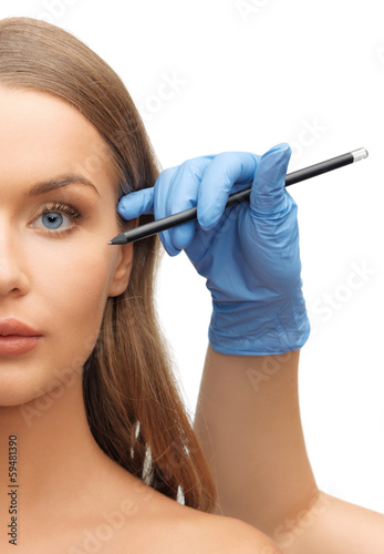 Photo: woman face and beautician hands woman face and beautician hands