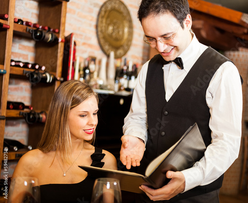 Photo: Waiter suggesting food in a restaurant Waiter suggesting food in a restaurant