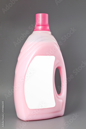 Photo: Transparent detergent plastic bottle isolated on gray, with blan Transparent detergent plastic bottle isolated on gray, with blan