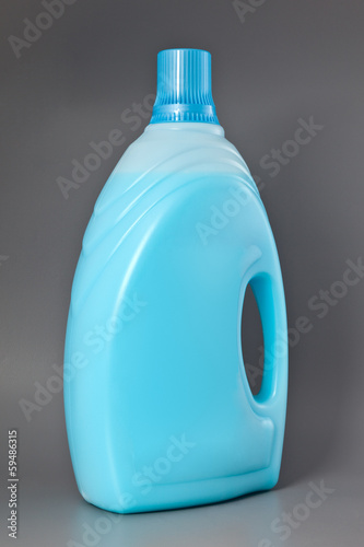 Photo: Transparent detergent plastic bottle isolated on gray Transparent detergent plastic bottle isolated on gray