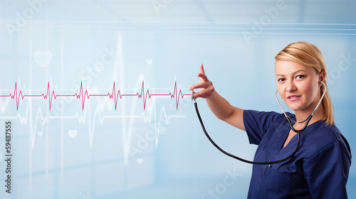 Photo: Pretty medical doktor listening to red pulse and heart rates Pretty medical doktor listening to red pulse and heart rates