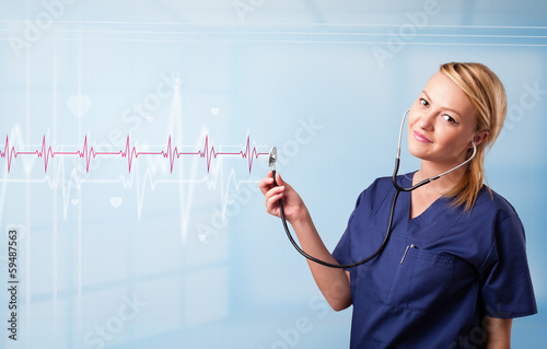 Photo: Pretty medical doktor listening to red pulse and heart rates Pretty medical doktor listening to red pulse and heart rates