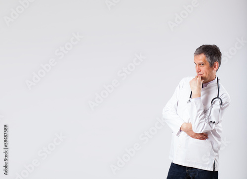 Photo: Doctor listening to empty copy space with stethoscope Doctor listening to empty copy space with stethoscope