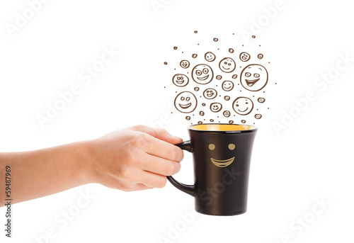 Photo: Coffee-cup with brown hand drawn happy smiley faces Coffee-cup with brown hand drawn happy smiley faces