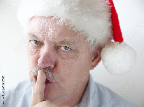 Photo: man in Santa hat asks for quiet man in Santa hat asks for quiet