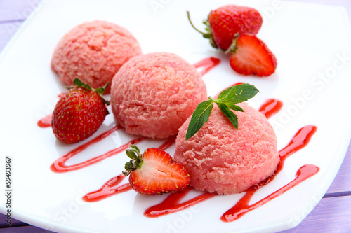 Photo: Delicious ice cream on plate on table close-up Delicious ice cream on plate on table close-up