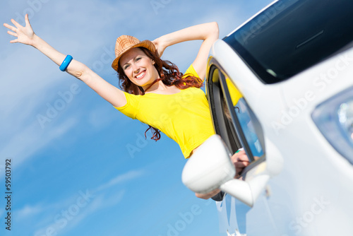 Photo: Young woman got out of car window Young woman got out of car window