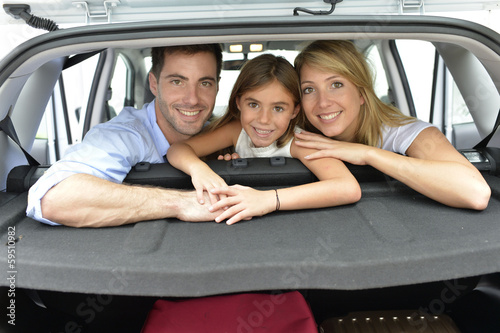 Photo: Cheerful family of three ready for vacation Cheerful family of three ready for vacation