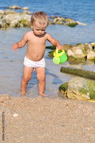 Photo: baby playing on the beach baby playing on the beach