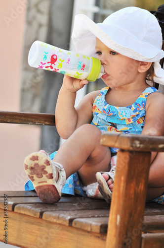 Photo: toddler with bottle of milk toddler with bottle of milk