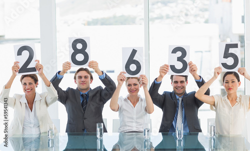 Photo: Group of panel judges holding score signs Group of panel judges holding score signs