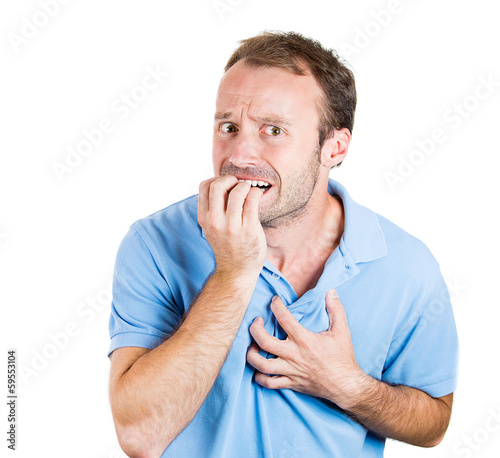 Photo: Stressed young man biting his fingernails, looking anxious Stressed young man biting his fingernails, looking anxious