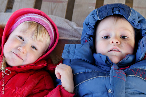 Photo: Cute boy and girl looking up at the camera Cute boy and girl looking up at the camera