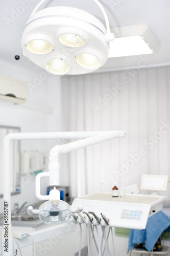Photo: Dentist tools and equipment against white background Dentist tools and equipment against white background