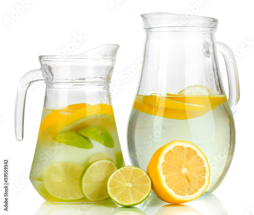Photo: Cold water with lime, lemon and ice in pitchers isolated Cold water with lime, lemon and ice in pitchers isolated