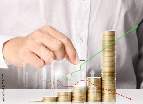 Photo: Hand put coin to money Hand put coin to money