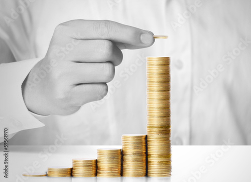 Photo: Hand put coin to money Hand put coin to money