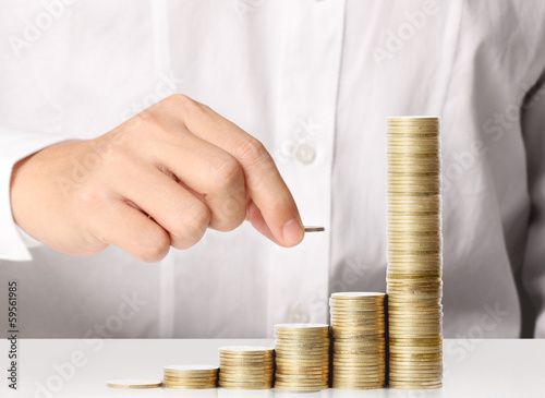 Photo: Hand put coin to money Hand put coin to money