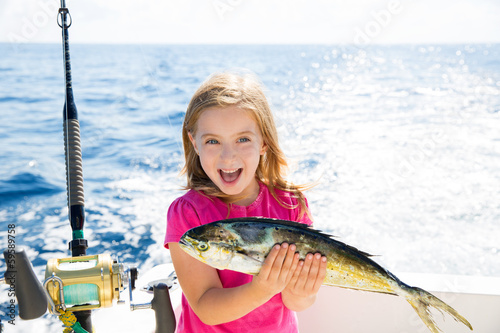 Photo: Blond kid girl fishing Dorado Mahi-mahi fish happy catch Blond kid girl fishing Dorado Mahi-mahi fish happy catch
