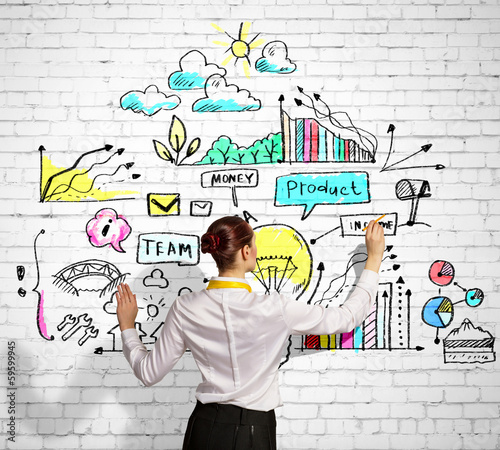 Photo: Businesswoman drawing on wall Businesswoman drawing on wall