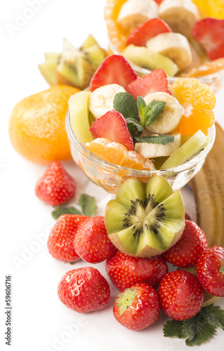 Photo: Bananas, kiwi and strawberry and glass bowl with fresh fruits Bananas, kiwi and strawberry and glass bowl with fresh fruits