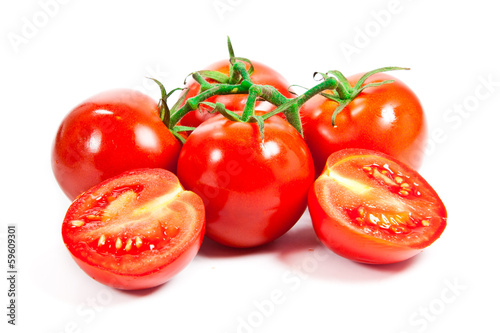 Photo: Closeup of tomatoes on the vine isolated on white Closeup of tomatoes on the vine isolated on white