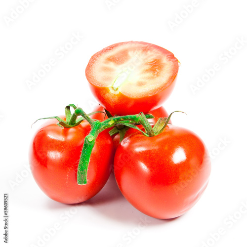 Photo: Closeup of tomatoes on the vine isolated on white Closeup of tomatoes on the vine isolated on white
