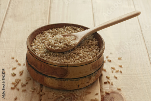 Photo: Brown rice in wooden bowl Brown rice in wooden bowl