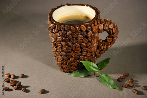 Photo: Cup of coffee beans, on grey background Cup of coffee beans, on grey background