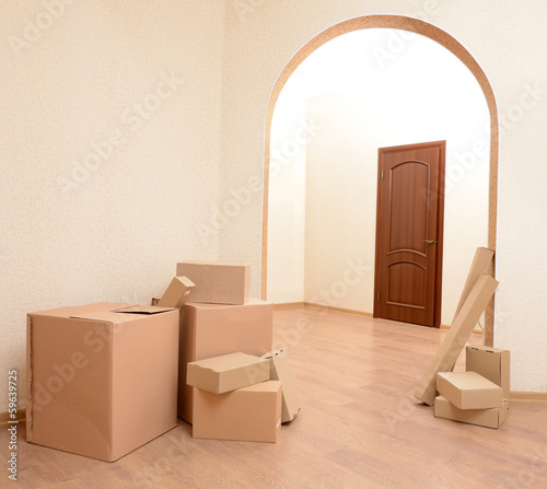 Photo: Empty room with stack of cartons: moving house concept Empty room with stack of cartons: moving house concept