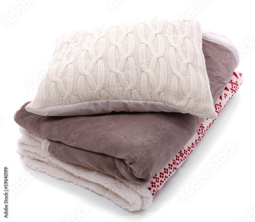 Photo: White pillow and colorful plaids isolated on white White pillow and colorful plaids isolated on white