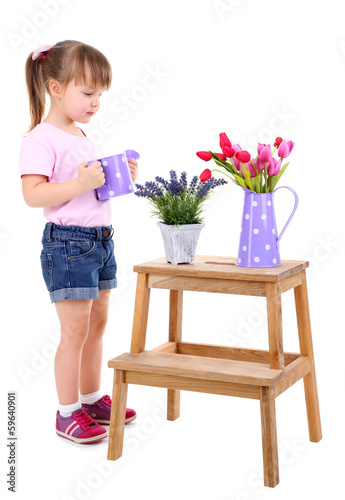 Photo: Beautiful little girl and stand with flowers isolated on white Beautiful little girl and stand with flowers isolated on white