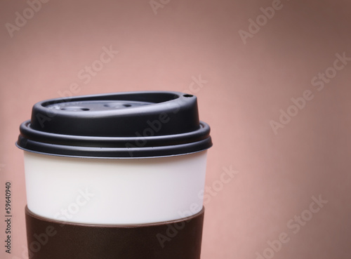 Photo: Paper Cup of Coffee on brown background. Takeaway or Disposable Paper Cup of Coffee on brown background. Takeaway or Disposable