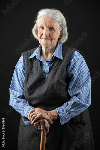 Photo: Portrait of a smiling senior woman looking at the camera Portrait of a smiling senior woman looking at the camera