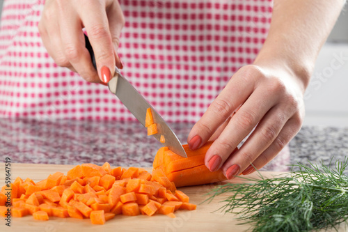 Photo: Woman chopping carrot Woman chopping carrot