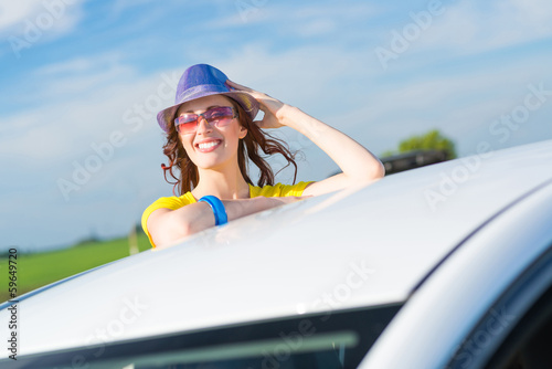 Photo: Young woman got out of car window Young woman got out of car window