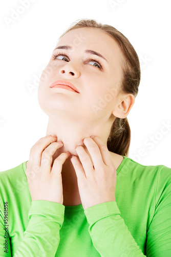Photo: Attractive woman scratching her neck. Attractive woman scratching her neck.